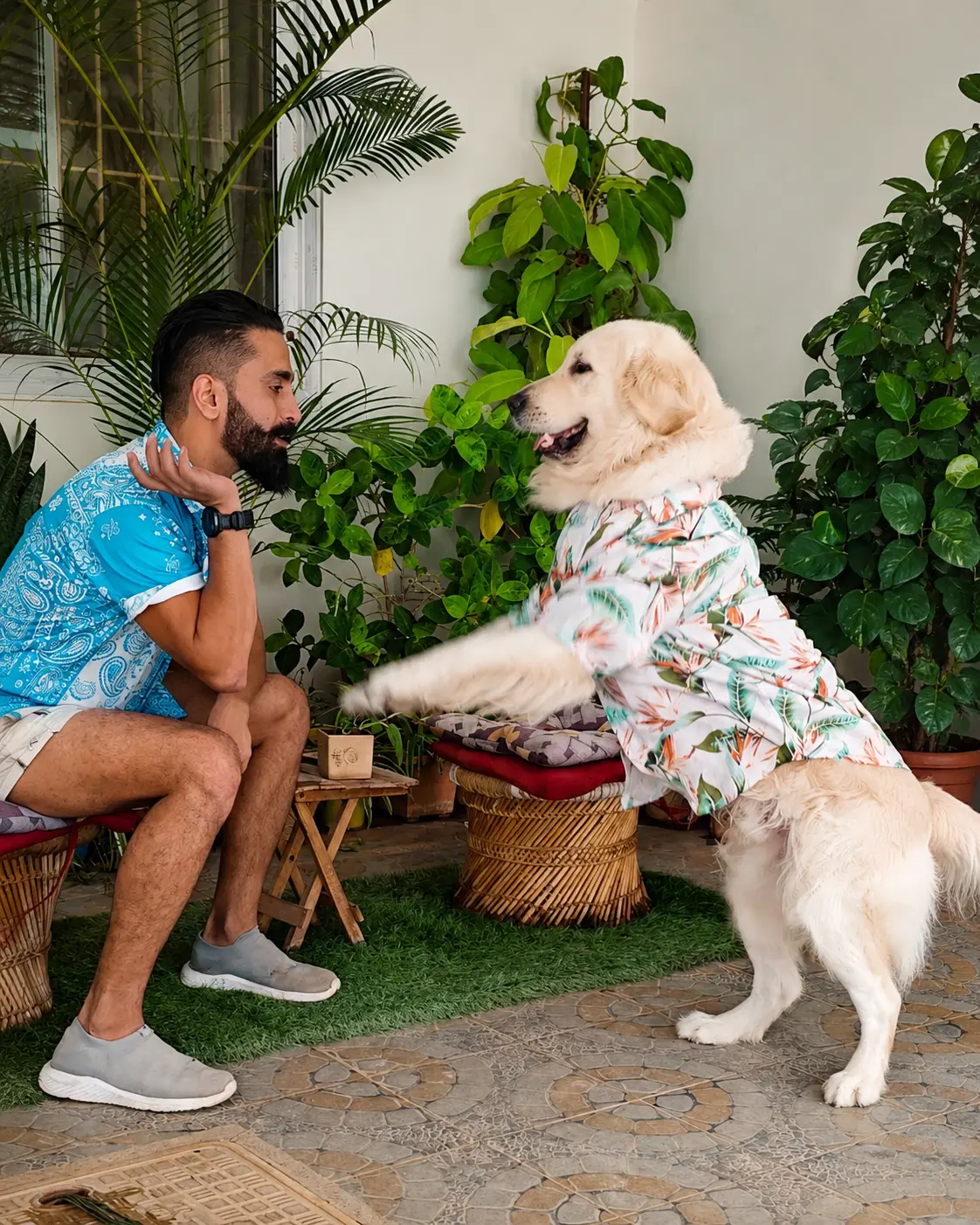 Vikram sharing a high five with a dog at Stay Floofy